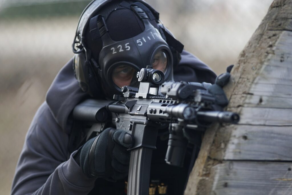 A shooter adjusting the turrets on a rifle scope