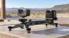 Adjustable shooting rest on a table at an outdoor range