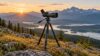 Spotting scope mounted on a field tripod at a mountain overlook